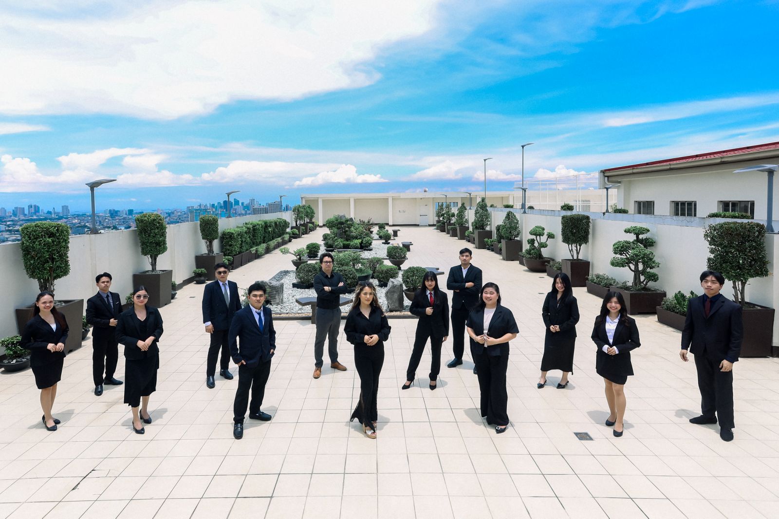 AMAC team standing across a rooftop terrace
